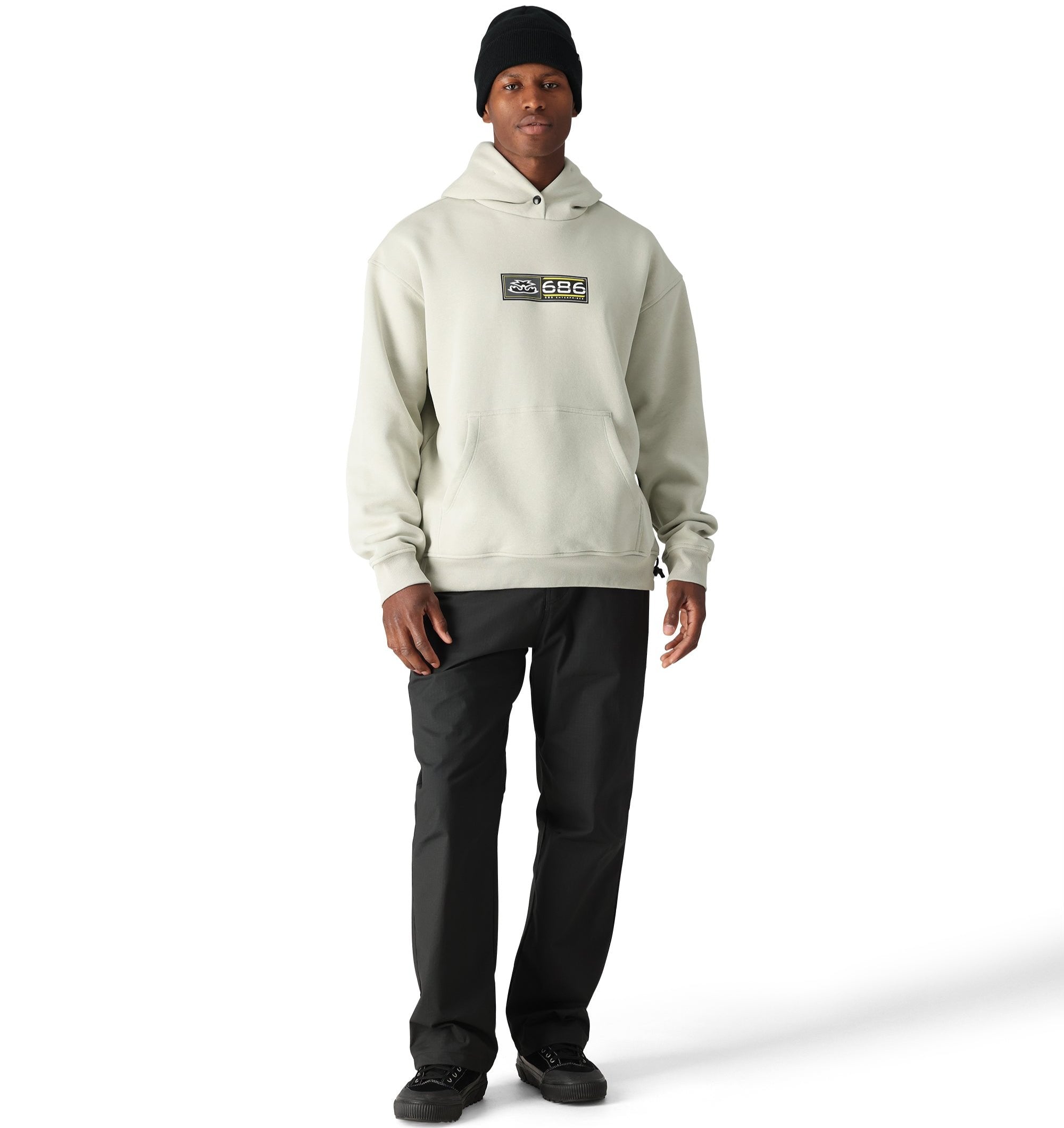 The 686 pullover hoody has a light gray color with a black logo and a kangaroo pocket on the front.