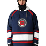 A man wearing a navy blue and white hooded sweatshirt with red stripes on the chest and sleeves, featuring the brand name '686' in small letters near the bottom hem.