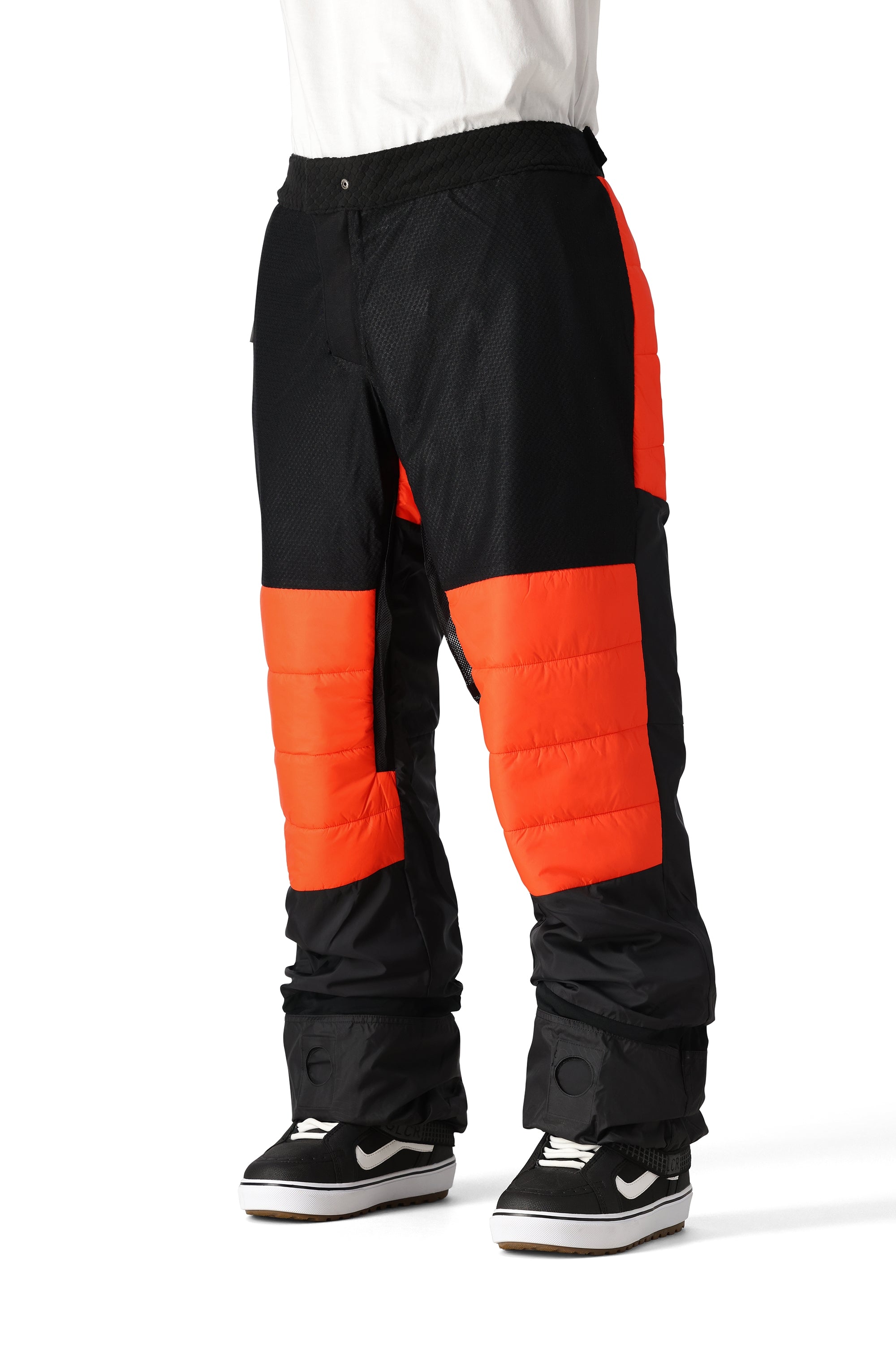The 686 Quantum Thermagraph Pant 2025 is black with an orange stripe down the side and an insulated hood.