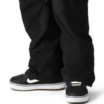 The 686 brand Quantum Thermagraph pant in this image appears to be black with an elastic waistband and zippered pockets.