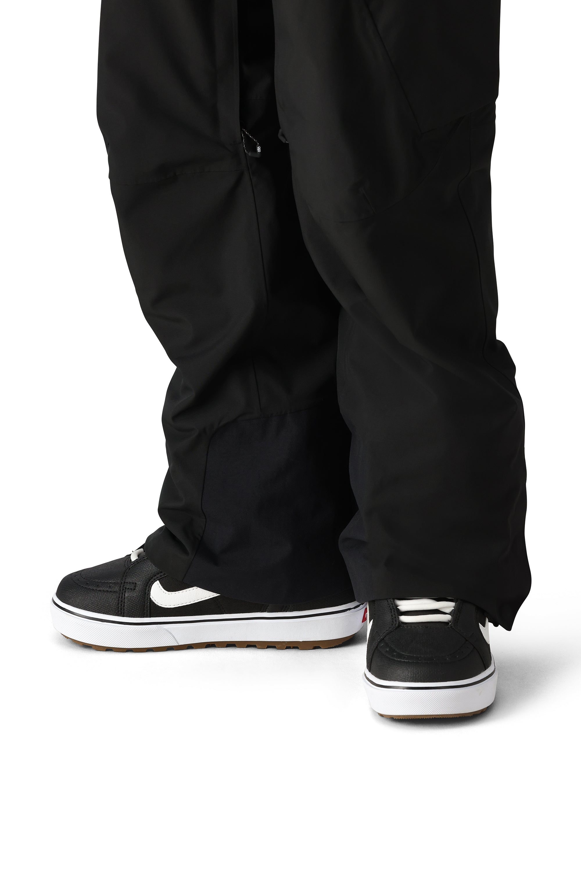 The 686 brand Quantum Thermagraph pant in this image appears to be black with an elastic waistband and zippered pockets.