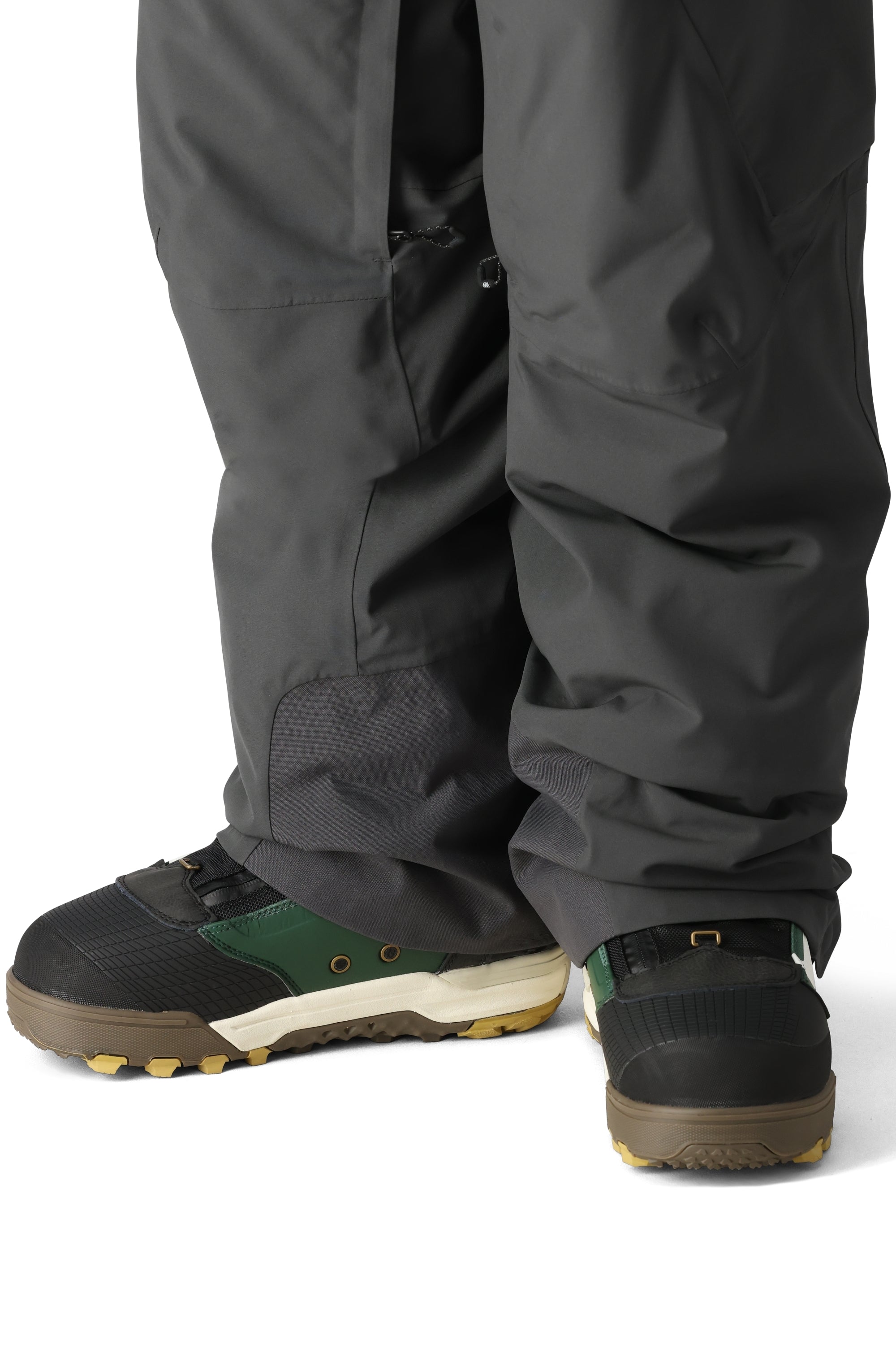 The 686 Men's Quantum Thermagraph Pant 2025 is dark gray with zippered pockets and a black drawstring on the waist.