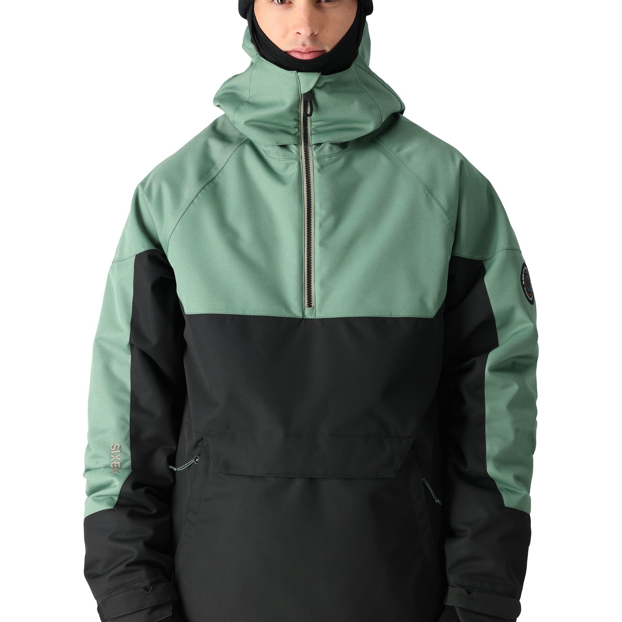 The Renewal Insulated Anorak Jacket by 686 boasts a striking combination of black and sage green hues.