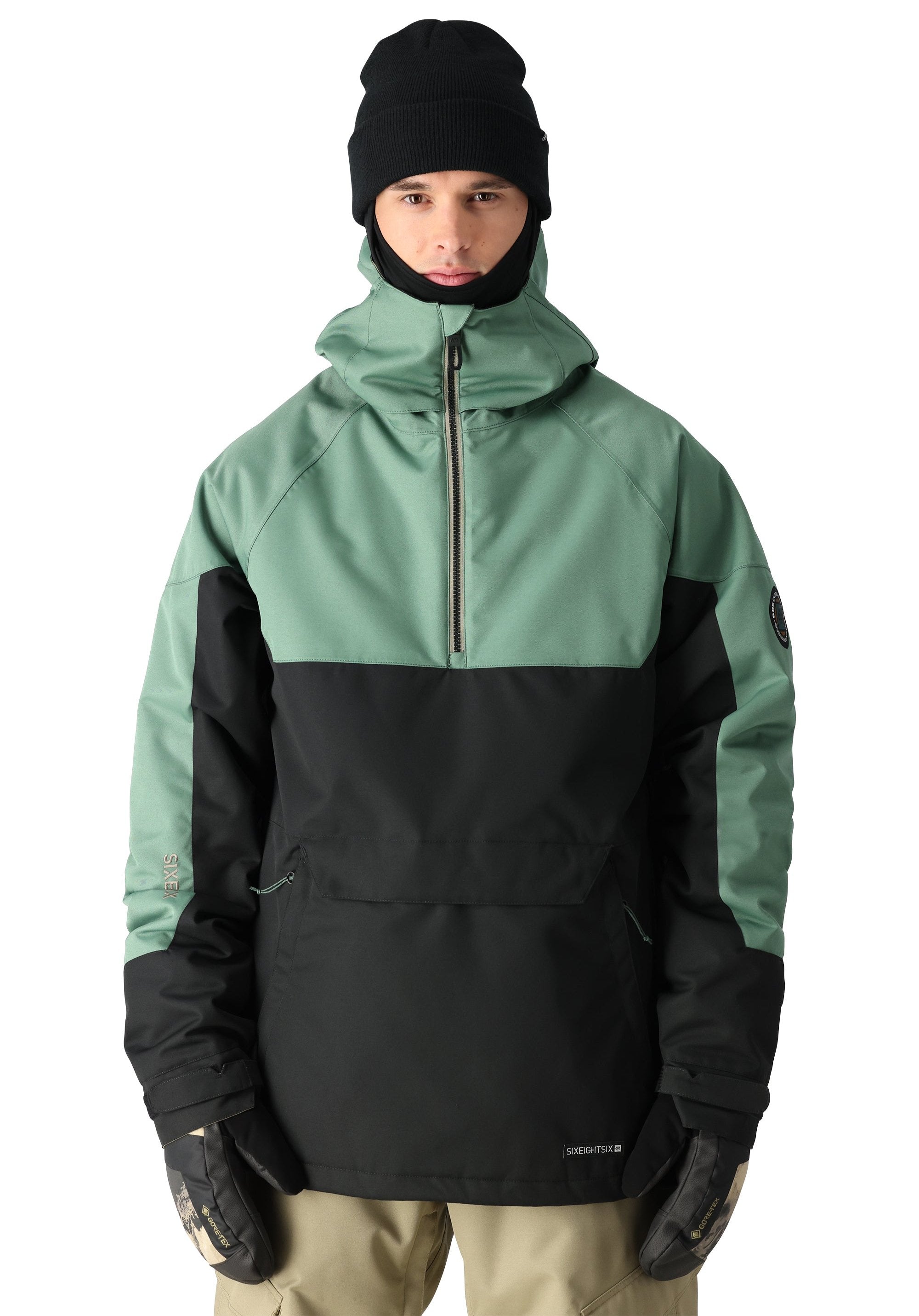 The Renewal Insulated Anorak Jacket by 686 boasts a striking combination of black and sage green hues.
