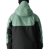 The 686 Renewal Insulated Anorak Jacket in this front view features a black body with mint-green shoulders and hood.