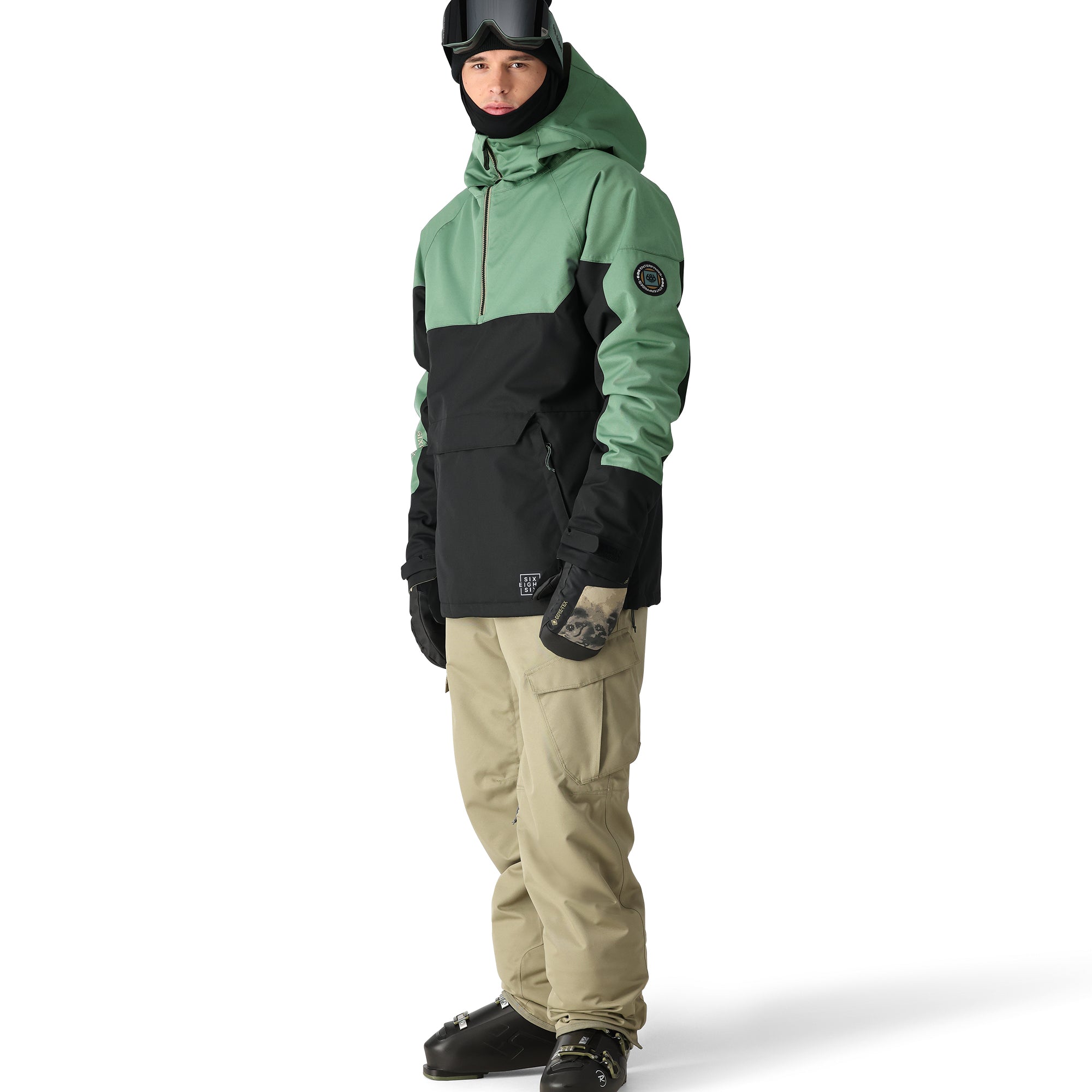 The 686 Renewal Insulated Anorak Jacket 2025 is black and green with an oversized hood.