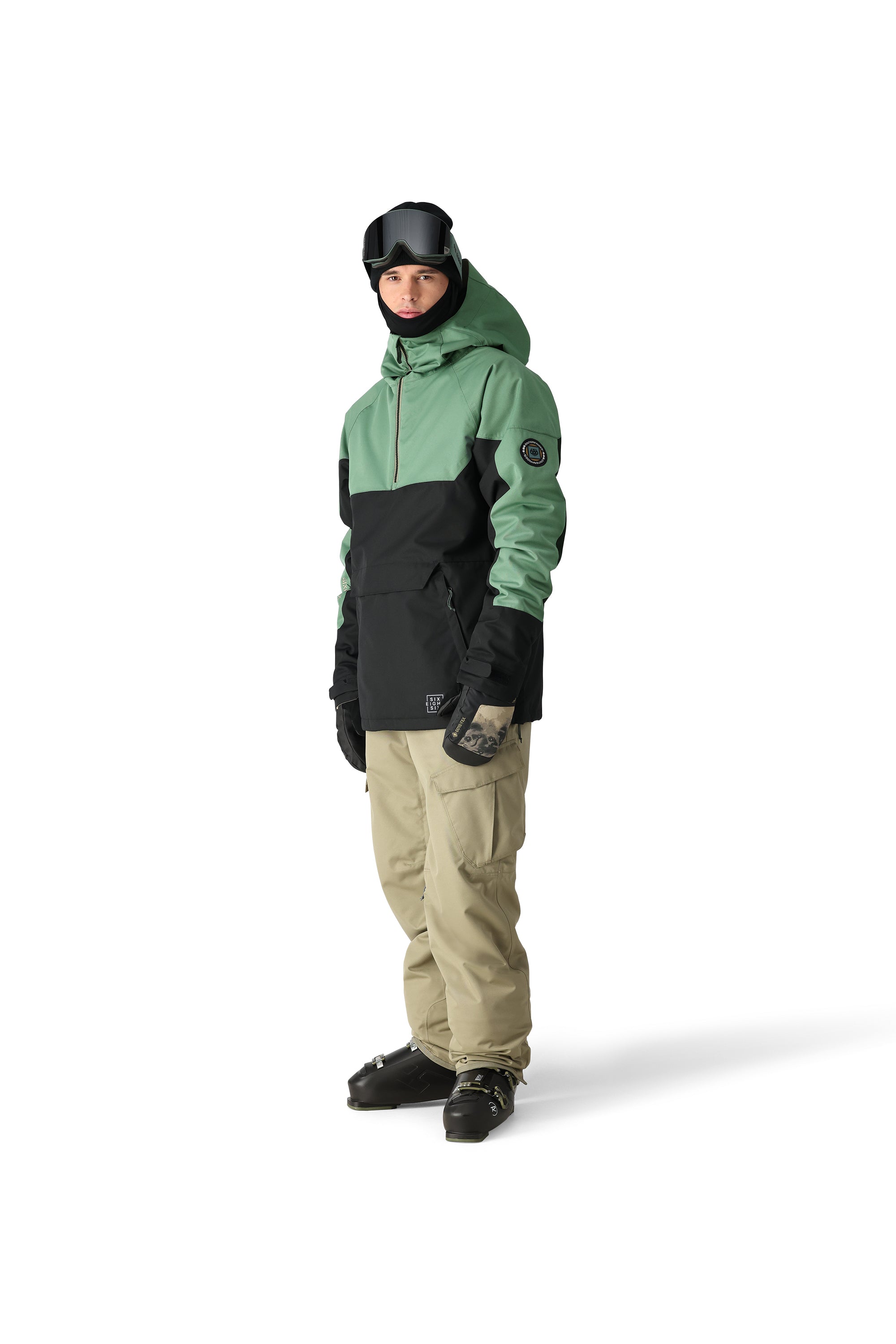 The 686 Renewal Insulated Anorak Jacket 2025 is black and green with an oversized hood.