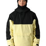 The 686 Renewal Insulated Anorak Jacket in black and cream has an oversized front pocket on the chest with a flap closure.