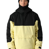 The 686 Renewal Insulated Anorak Jacket in black and cream has an oversized front pocket on the chest with a flap closure.