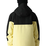 The 686 Renewal Insulated Anorak Jacket features a black and yellow color scheme with an adjustable hood.