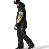 The 686 Renewal Insulated Anorak Jacket 2025 is black with an oversized hoodie and a bold graphic on the sleeve.