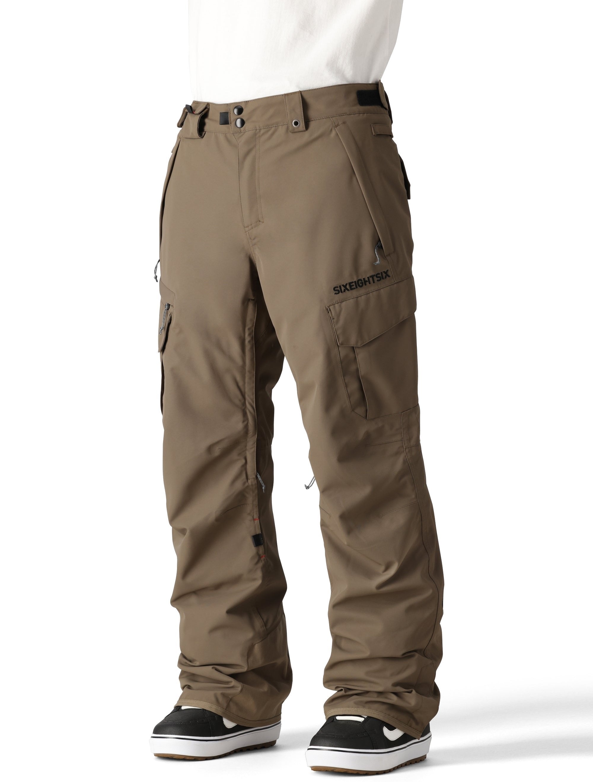 The 686 brand's SMARTY 3-in-1 Cargo Pant features a dark brown color with cargo pockets and a zippered fly.