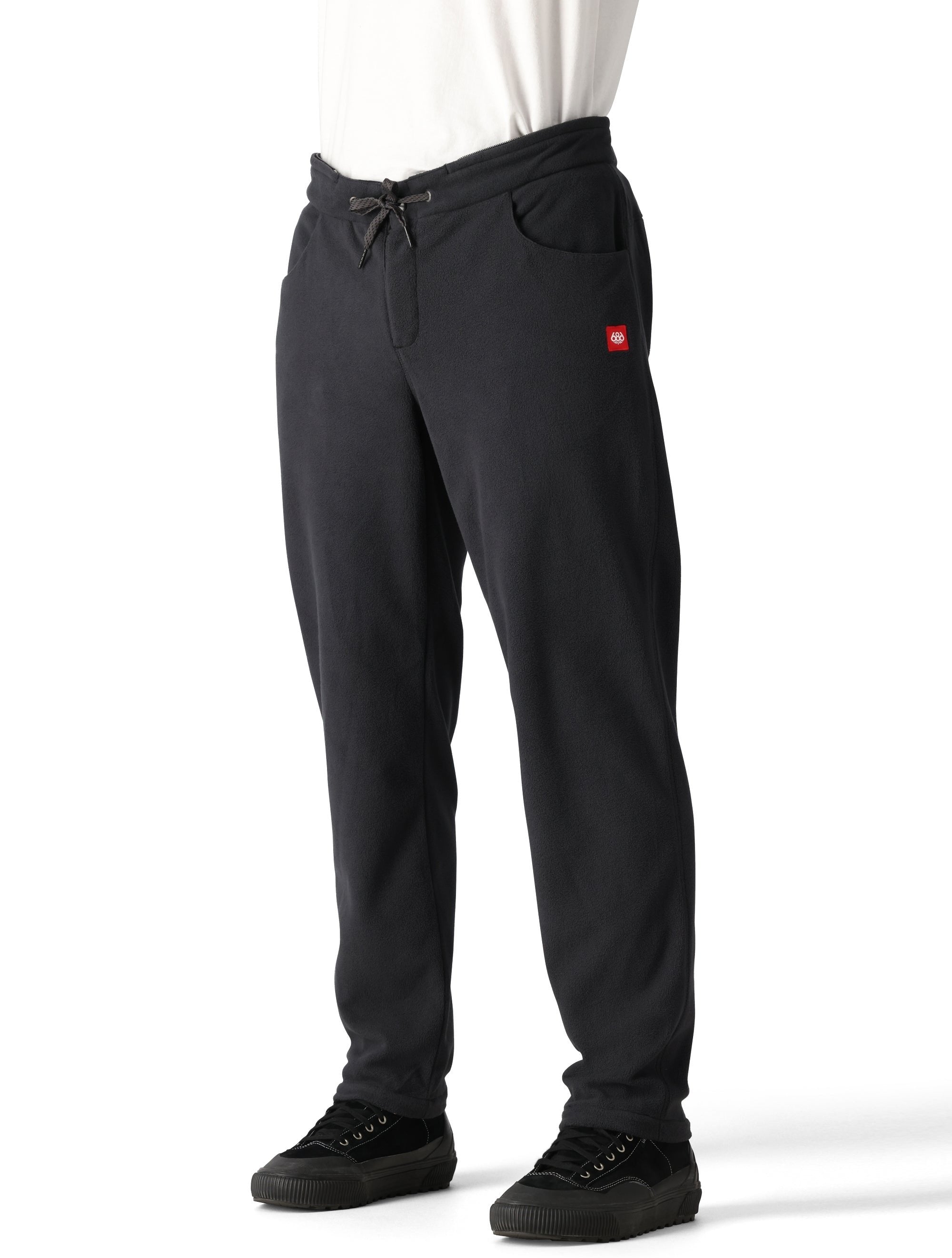 The 686 Men's SMARTY 3-in-1 Cargo Pant 2025 is black with a red logo on the left thigh and has two side cargo pockets.