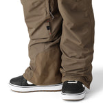 The 686 brand SMARTY 3-in-1 Cargo Pant in brown features cargo pockets on each thigh and has an adjustable waistband with a zipper fly.