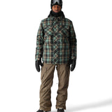 The 686 Smarty 3-in-1 cargo pant in this front view is green and brown plaid with black accents.