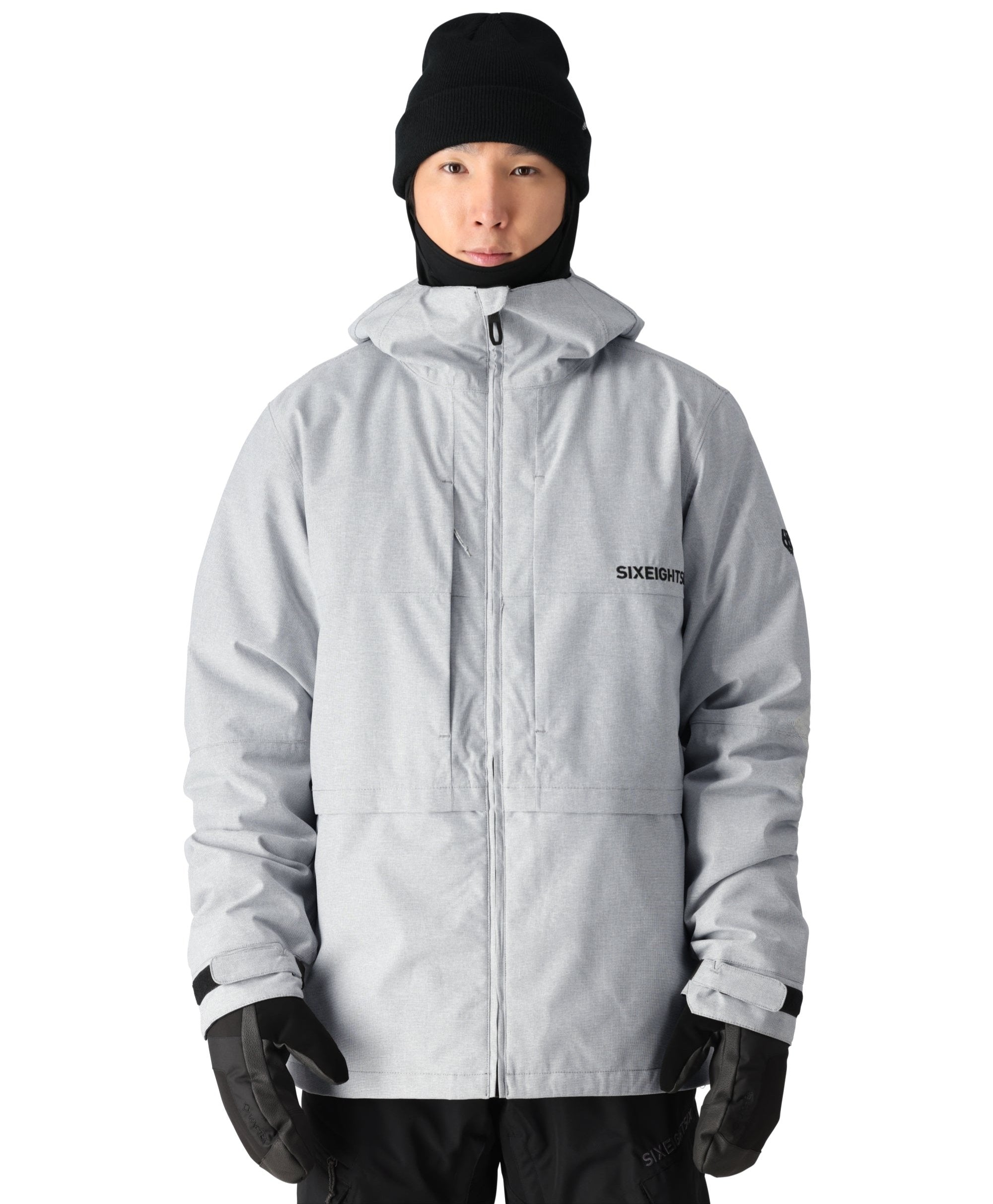 A light gray 686 Smarty 3-in-1 form jacket with a black hood and a zipper down the front.