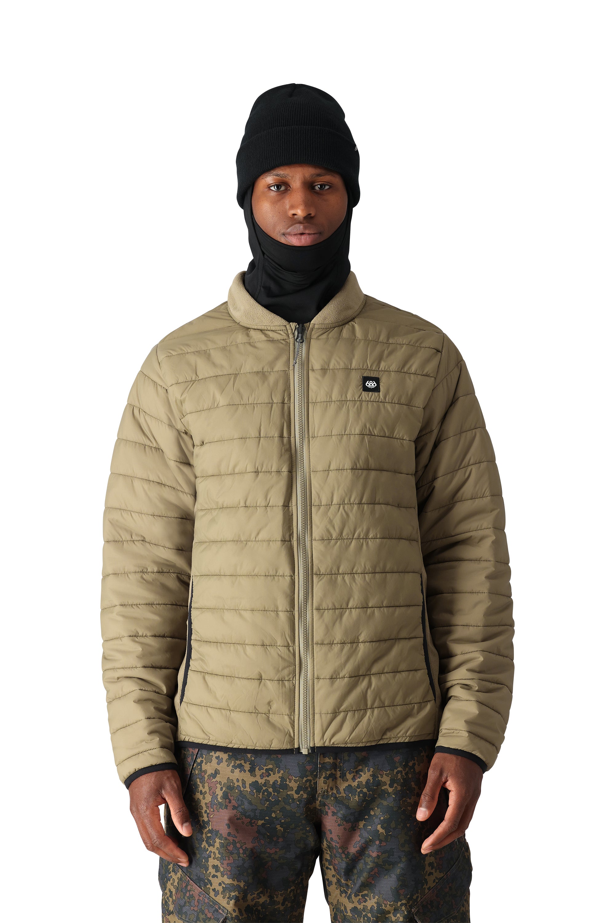 The 686 Smarty 3-in-1 Form Jacket is primarily tan with black accents on the side zippers and collar trim.