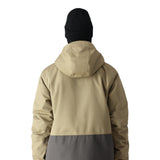 The 686 Smarty 3-in-1 Form Jacket in khaki and gray has an oversized zippered chest pocket on the front view.