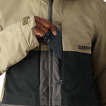 The 686 Smarty 3-in-1 Form Jacket in tan and black has an insulated hood.