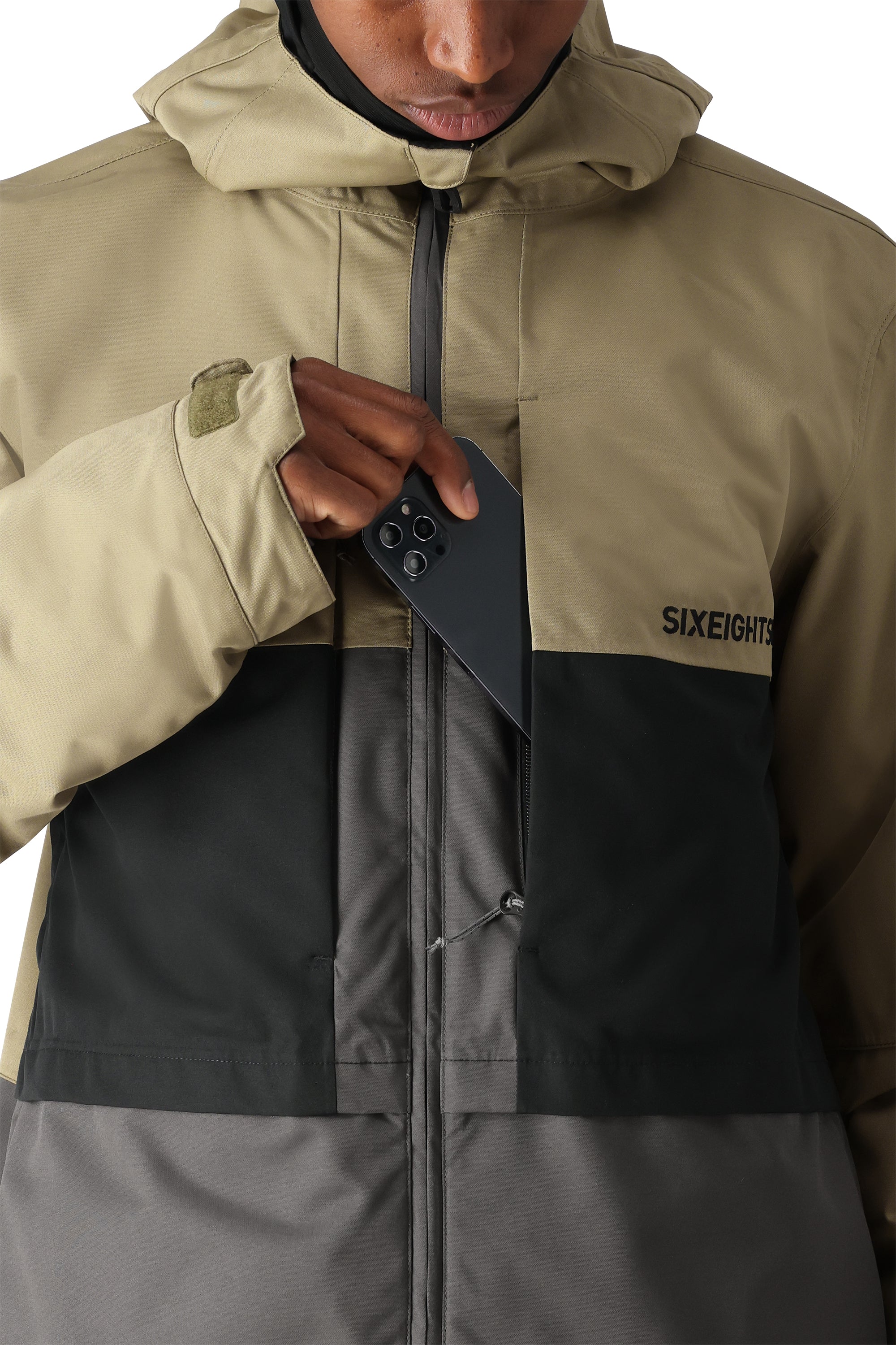The 686 Smarty 3-in-1 Form Jacket in tan and black has an insulated hood.