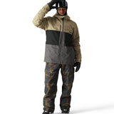 The 686 Smarty 3-in-1 Form Jacket is primarily khaki with a black stripe across the chest and a gray panel at the bottom.