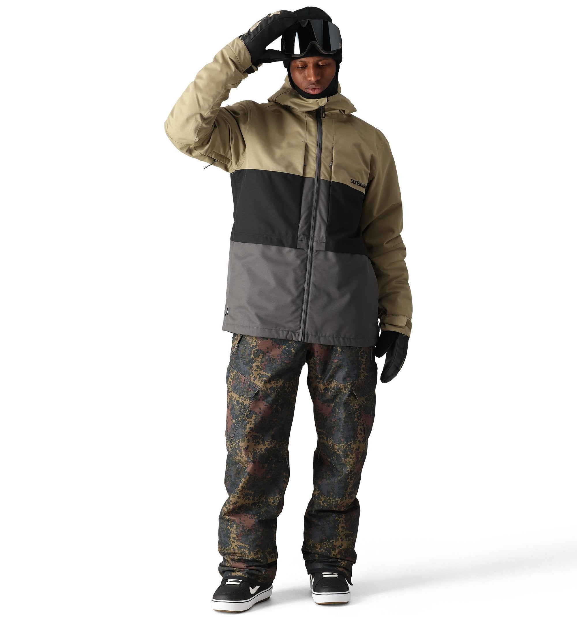 The 686 Smarty 3-in-1 Form Jacket is primarily khaki with a black stripe across the chest and a gray panel at the bottom.