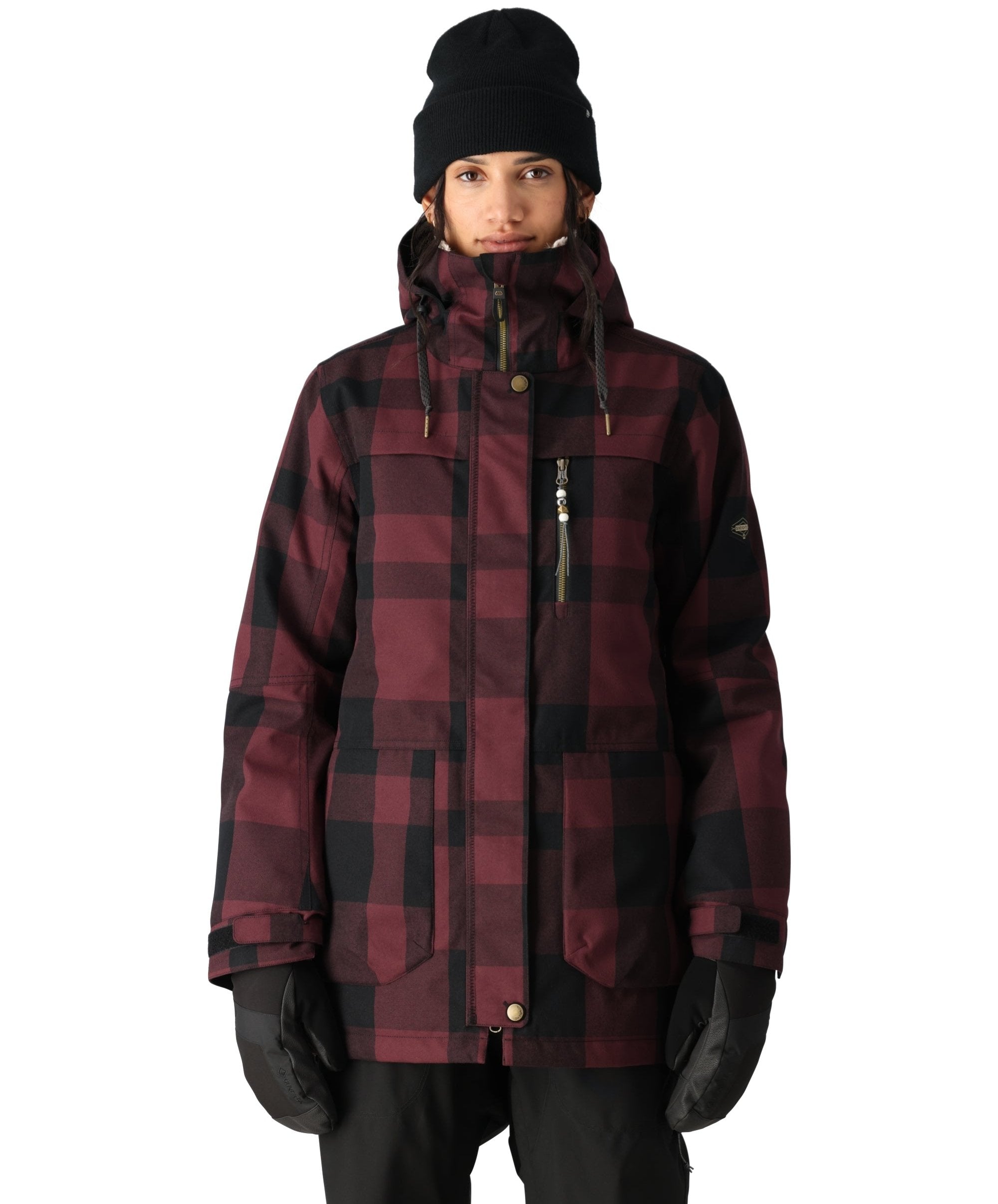 The 686 Women's Spirit Insulated Jacket 2025 is primarily maroon with black plaid and has an insulated hood.