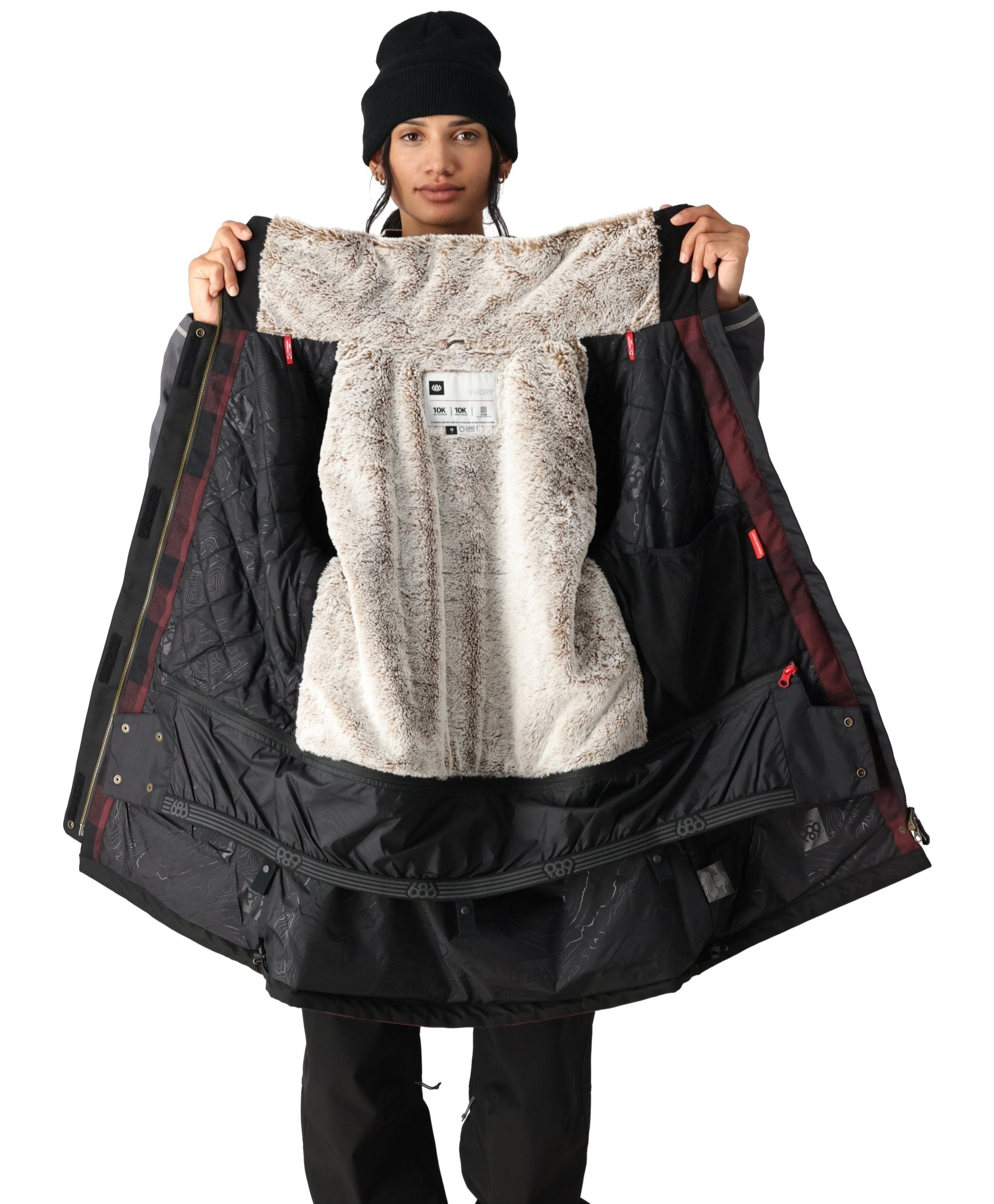 The 686 Spirit Insulated Jacket is predominantly black with brown accents and a white faux-fur trim.