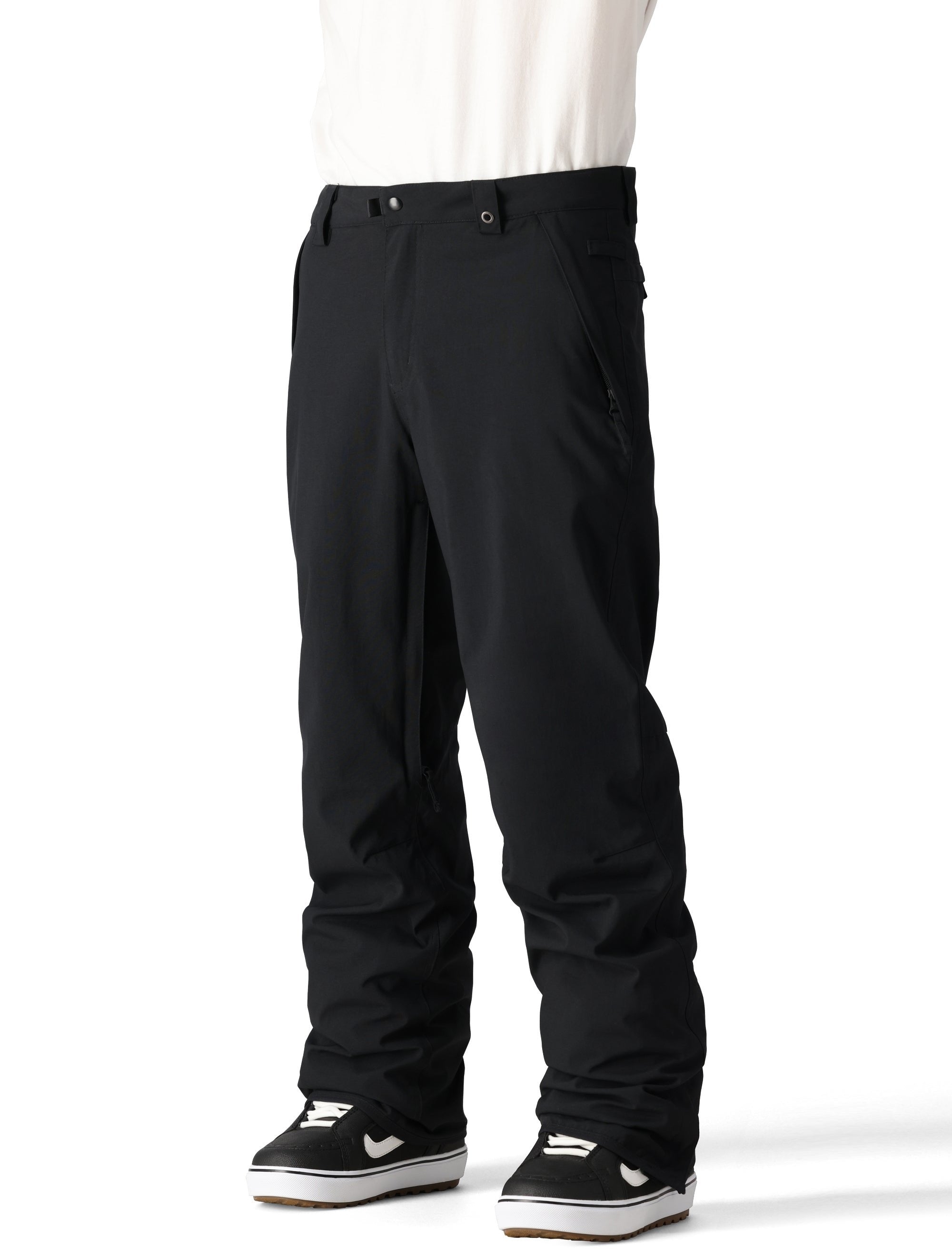 The 686 Men's Standard Shell Pant 2025 is black with a zippered pocket on the side and belt loops.