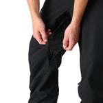 The 686 Men's Standard Shell Pant 2025 is black with a zippered leg opening and a breathable mesh lining.