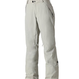 The 686 Women's Standard Shell Pant 2025 is primarily white with black accents and has zippered pockets along the sides.