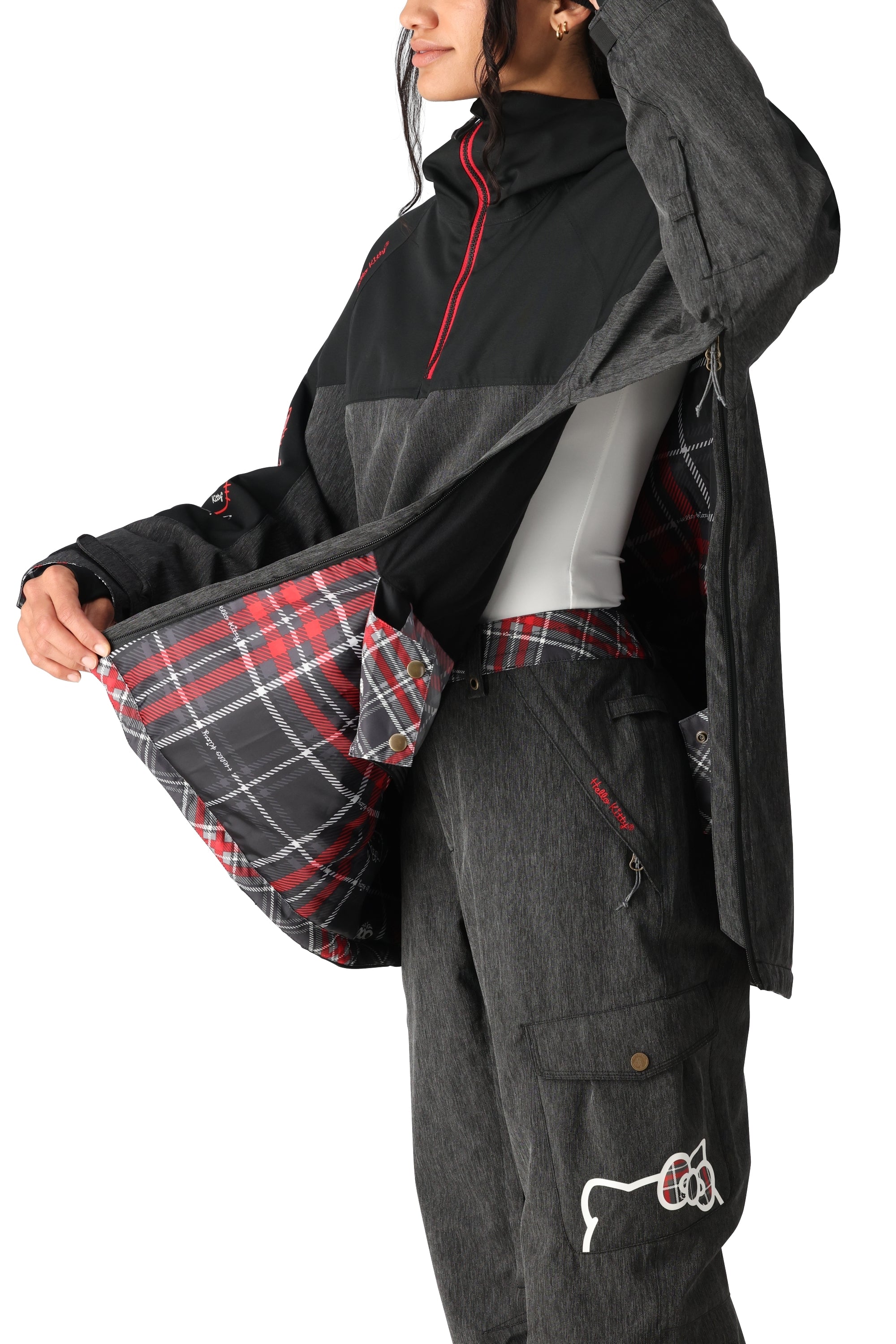 The 686 Women's Upton Insulated Anorak Jacket features a black and red plaid pattern on the inside lining and an adjustable hood.