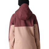 The 686 Women's Upton Insulated Anorak Jacket 2025 is primarily a muted pink jacket with a burgundy hood and black trim.