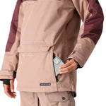 The 686 Women's Upton Insulated Anorak Jacket in tan and maroon has a front zipper and an insulated hood.