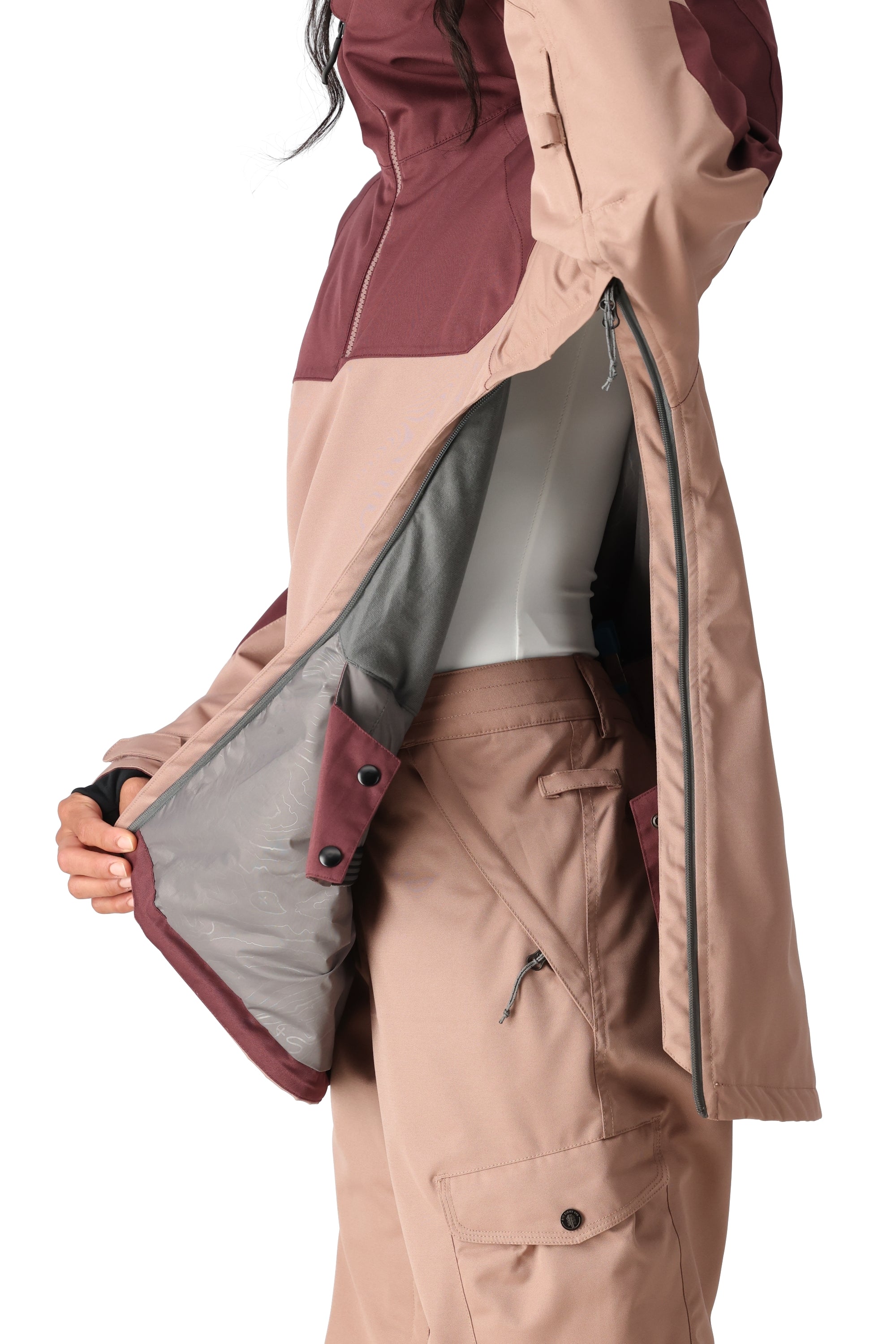 The 686 Women's Upton Insulated Anorak Jacket 2025 is a tan and maroon jacket with an insulated hood, as seen from the front view.