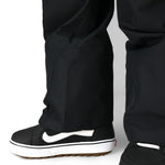 Women’s black Thermagraph ski pants with ankle opening and cushioned strap footwear