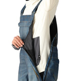 The 686 Black Magic 20K shell bib has a dark blue color and a distinctive black stripe running down the side.