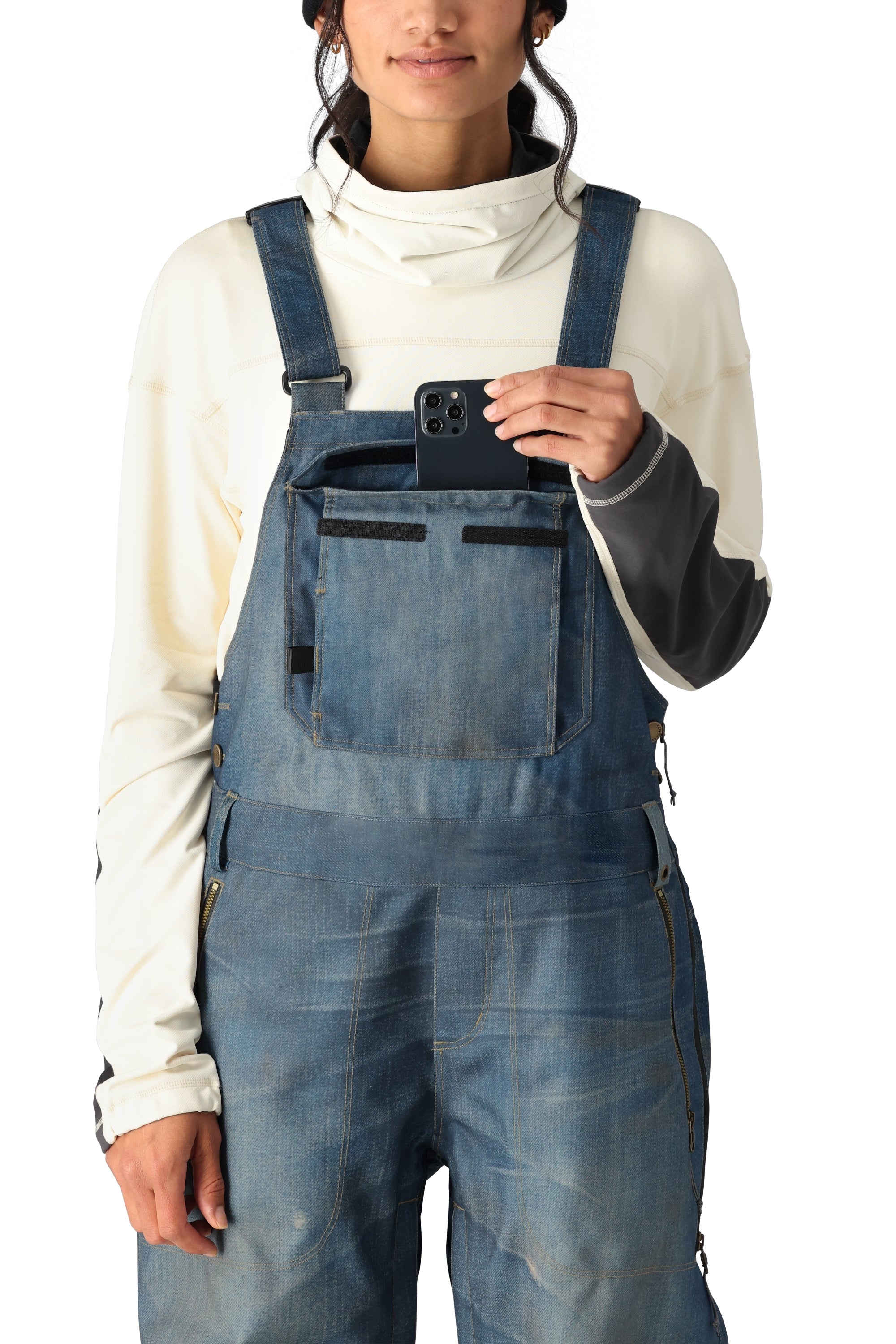 The 686 Women's Black Magic 20K Shell Bib features a light-colored shell with black trim and adjustable straps.