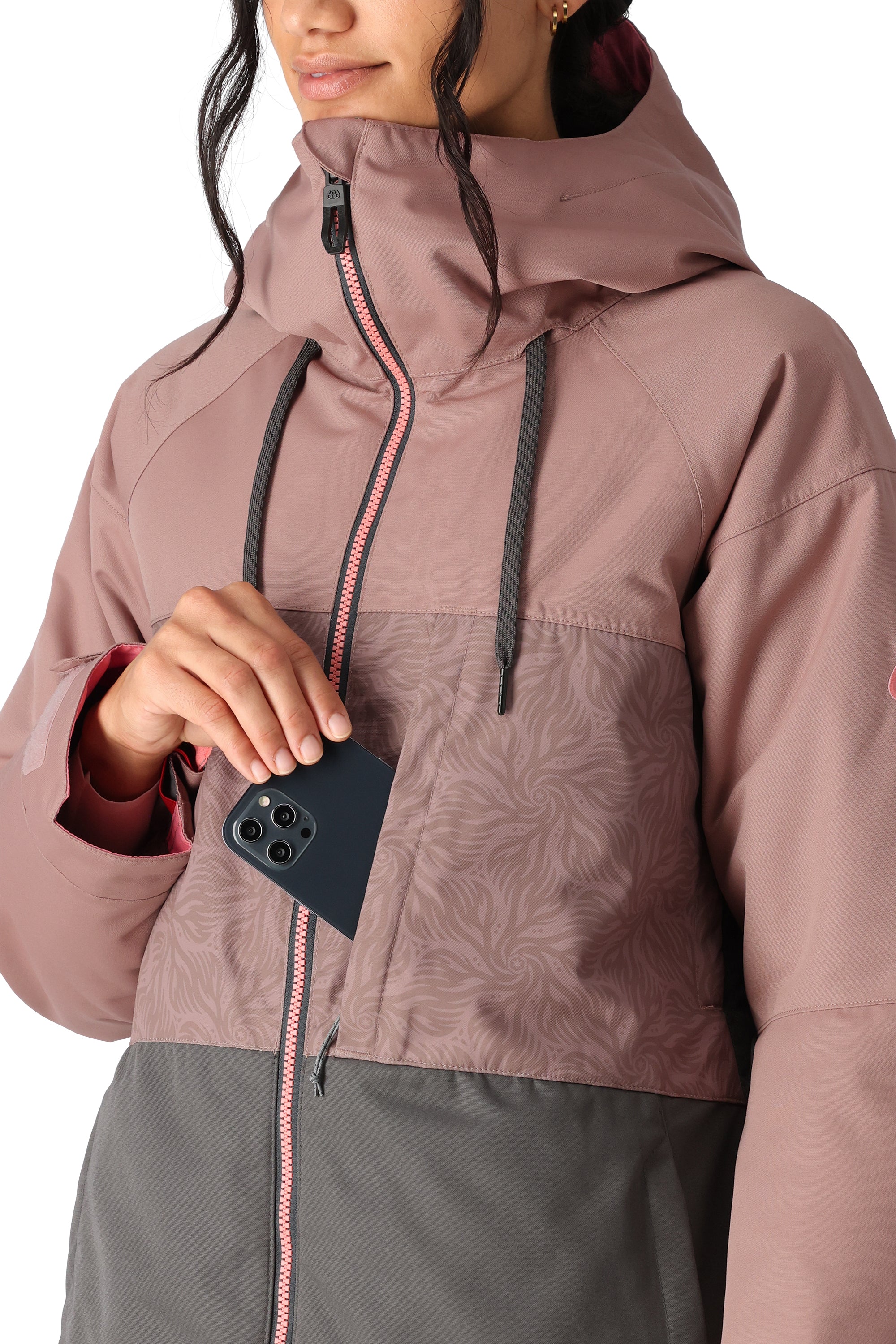 The 686 brand Athena insulated jacket has a pink top section with a swirling pattern and a gray bottom section.
