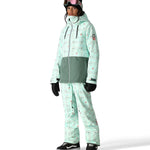 The 686 Women's Athena Insulated Jacket 2025 has a light green color with a pattern of small pink and gray snowflakes.