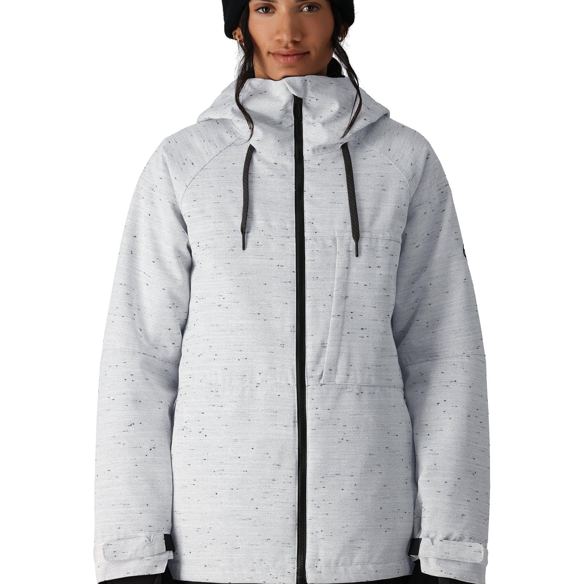 The 686 Women's Athena Insulated Jacket 2025 is primarily white with black speckles and has a black zipper down the front.