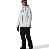 The 686 Women's Athena Insulated Jacket 2025 is predominantly white with black speckles and features a zippered front, drawstring hood, and thumbholes in black.