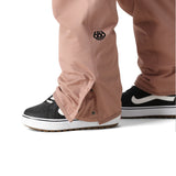 The 686 Women's Aura Insulated Cargo Pant 2025 is primarily pink with black accents and a zipper down the front.