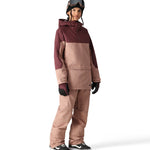 The 686 Aura Insulated Cargo Pant in a brown color with zippered pockets and an adjustable waistband is shown from the side view.