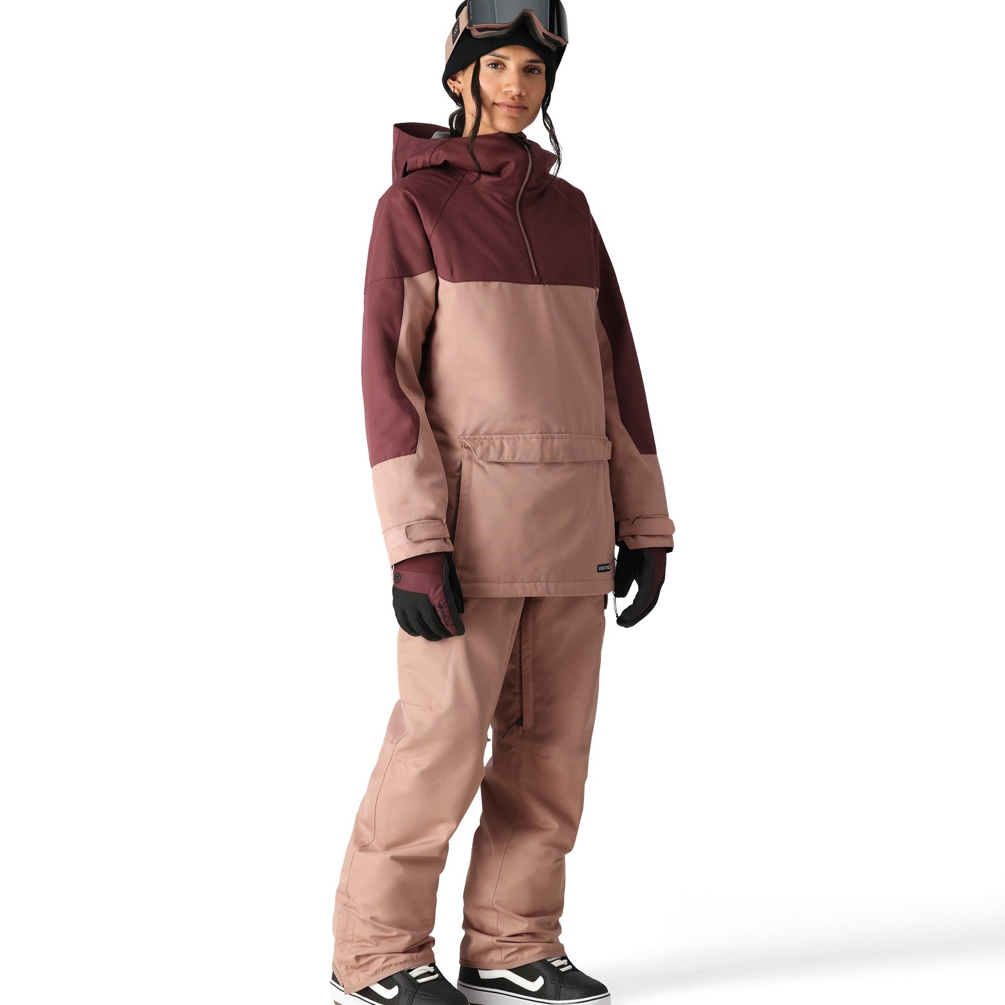 The 686 Aura Insulated Cargo Pant in a brown color with zippered pockets and an adjustable waistband is shown from the side view.