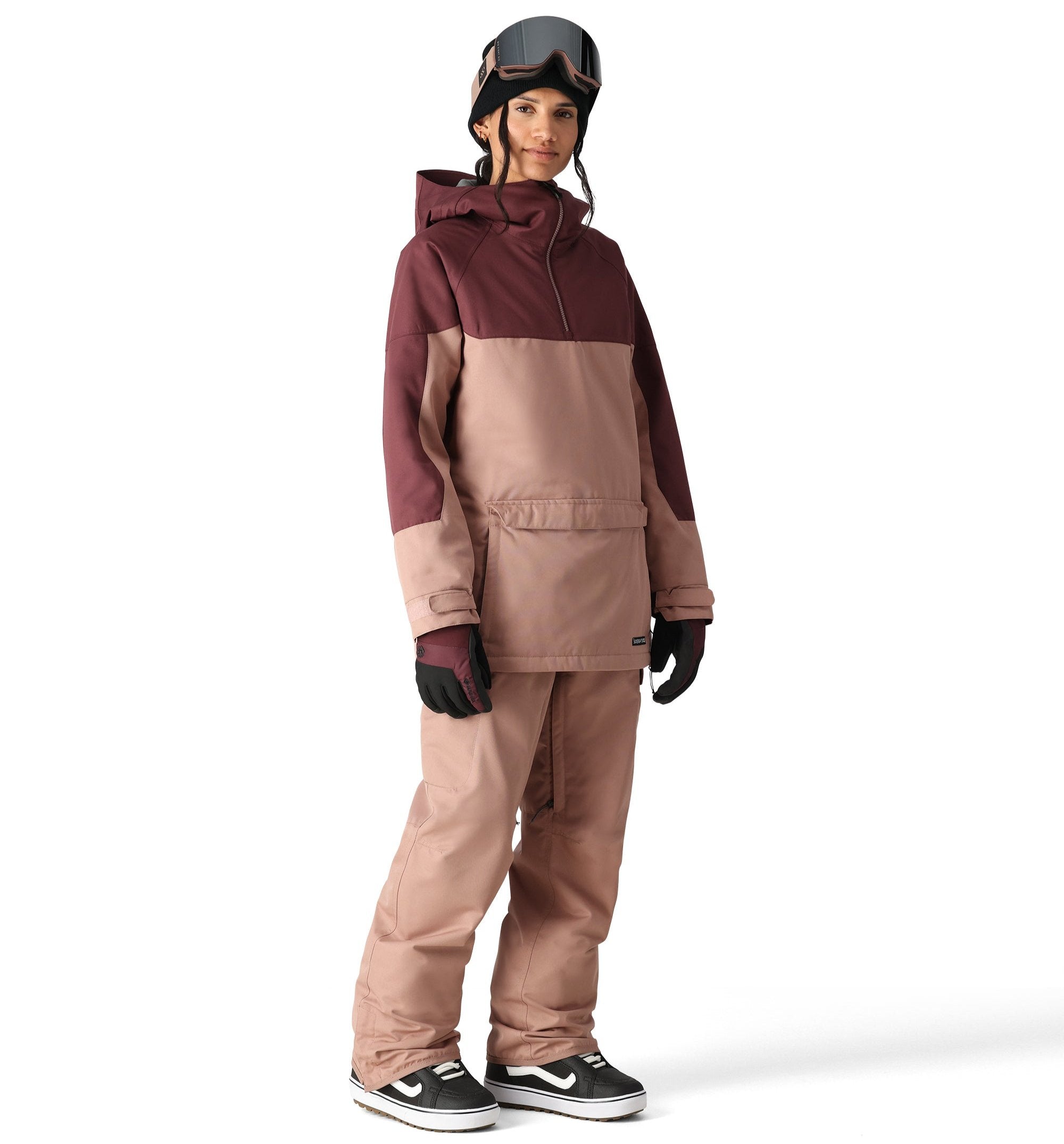 The 686 Aura Insulated Cargo Pant in a brown color with zippered pockets and an adjustable waistband is shown from the side view.
