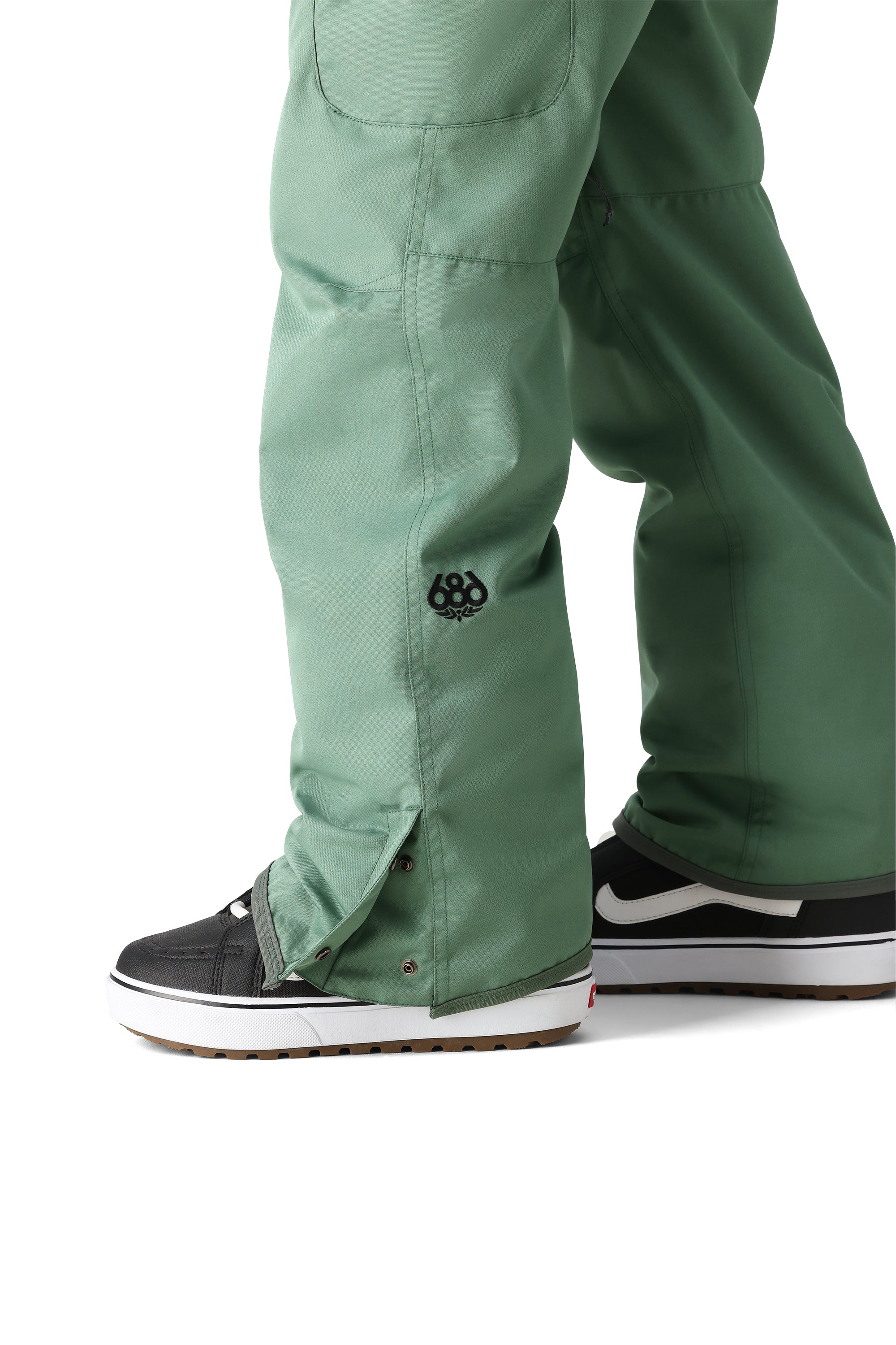 The 686 brand's Women's Aura Insulated Cargo Pant 2025 is showcased in this image, with a visible sage green color and cargo pockets.