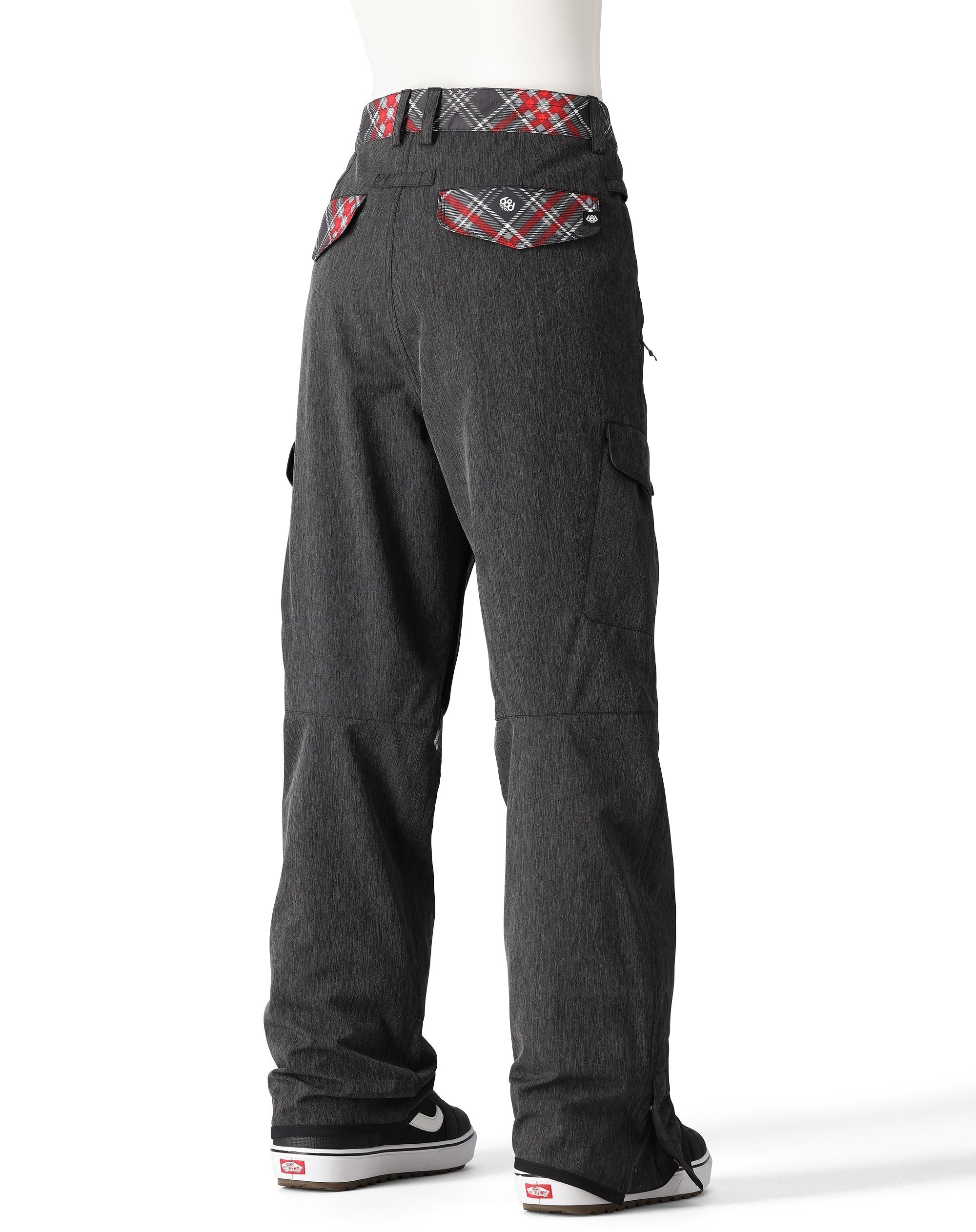 The 686 Women's Aura Insulated Cargo Pant 2025 in dark gray has two cargo pockets on either side and a red, white, and gray plaid waistband.