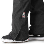 The 686 Women's Aura Insulated Cargo Pant 2025 is depicted in dark gray with a red and white logo on the thigh.