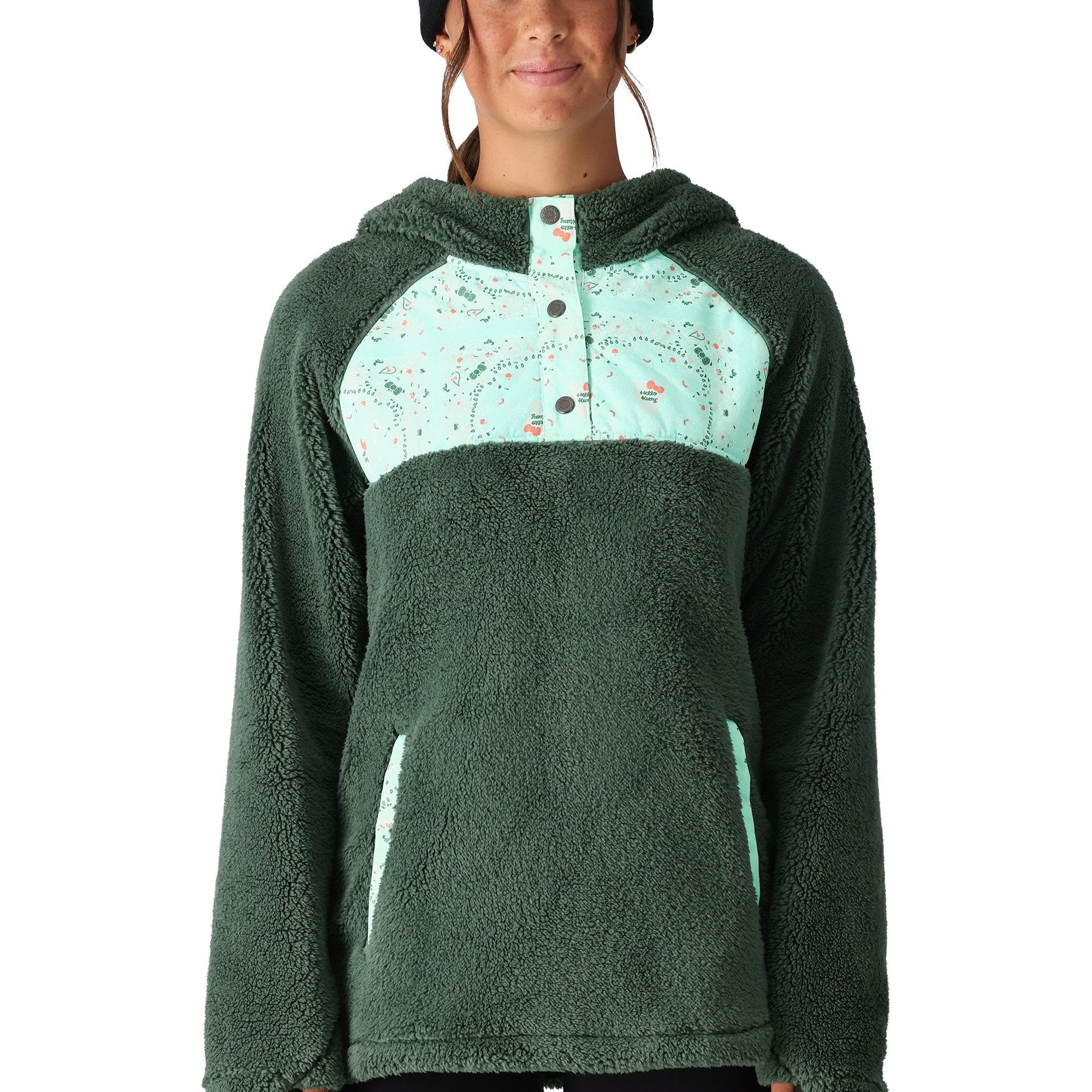 The 686 Women's Hemlock Sherpa Fleece Hoody 2025 is depicted in a dark green color with a light green patterned chest section.